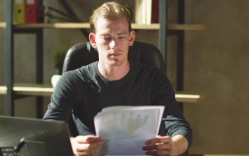Video Stock Businessman Looks Over Finance Reports And Frowns For PC