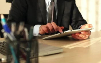 Video Stock Businessman In The Office Using His Tablet For PC