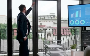 Video Stock Businessman In Suit Thinks In Front Of Office Windows For PC