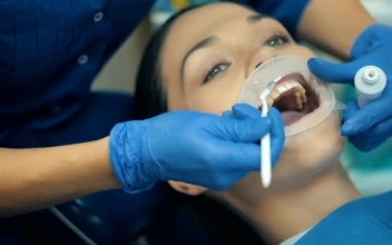 Stock Video Dentist Hands Cleaning Teeth To A Patient For PC
