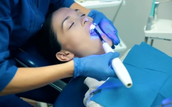 Stock Video Dentist Applying Blue Light To His Patient For PC
