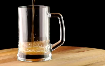 Stock Video Dark Beer Poured Into A Transparent Mug For PC