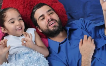 Stock Video Dad And Daughter Lying Excitedly Watching A Video On A For PC
