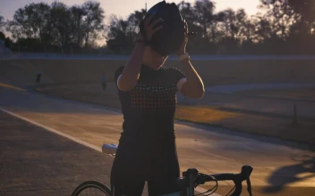 Stock Video Cyclist Putting On Her Helmet Before Training For PC
