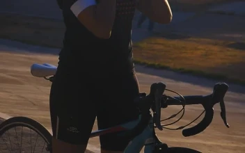 Stock Video Cyclist Girl Putting On Her Helmet Before Training For PC