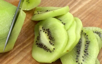 Stock Video Cutting Up Kiwi On A Table For PC