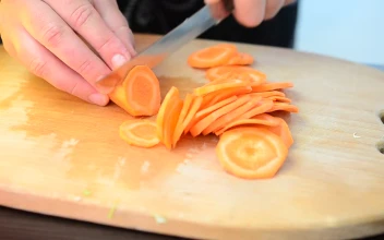 Stock Video Cutting Up Carrots On A Chopping Board For PC