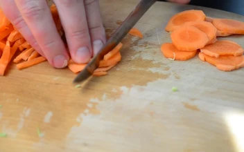 Stock Video Cutting Up Carrots Into Small Chunks For PC