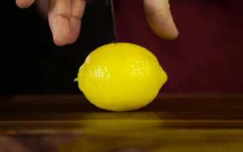 Stock Video Cutting Through A Lemon With A Knife For PC