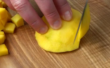 Stock Video Cutting Mango On A Board Close Up For PC