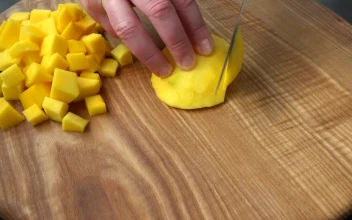 Stock Video Cutting Mango Cubes On A Board For PC