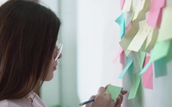 Stock Video Creative Woman Writing Ideas On Sticky Notes For Marketing Project For PC