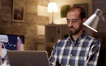 Stock Video Creative Man Stops To Think While Working On Laptop For PC