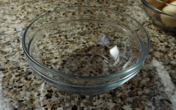 Stock Video Cracking A Raw Egg Into A Glass Bowl For PC