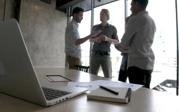 Stock Video Coworkers Standing By A Window For PC