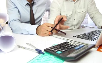 Stock Video Coworkers Discussing A Project With A Laptop For PC