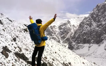 Stock Video Courageous Hiker Spreads Arms Over Mountain Summit For PC