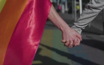 Stock Video Couple Walking In The Street With A Rainbow Flag For PC