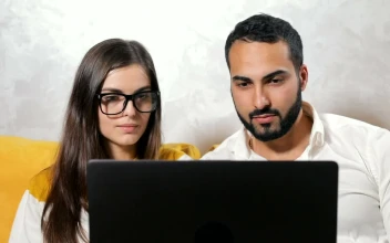 Stock Video Couple Surprised By What They See On Their Laptop For PC