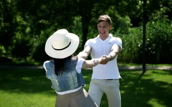 Stock Video Couple Spin Each Other Around In Sunny Park For PC