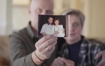 Stock Video Couple Showing An Old Photograph Of Them For PC