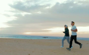 Stock Video Couple Out For A Run On The Beach For PC