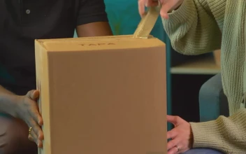Stock Video Couple Opening A Package With An Alarm Clock For PC