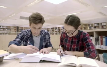 Stock Video Couple Of Students At The Library For PC