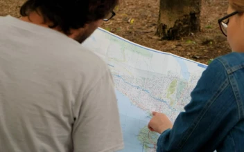 Stock Video Couple Of People Reviewing A Large Map Sitting In A For PC