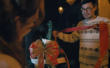 Stock Video Couple Of Man And Woman Decorating A Christmas Tree For PC
