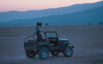 Stock Video Couple Of Friends Traveling Through A Desert On A Road For PC