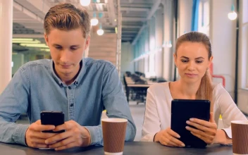 Stock Video Couple In A Cafe Connected On Their Mobile Devices For PC