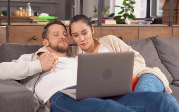Stock Video Couple Holding Each Other In An Armchair Watching A Movie For PC