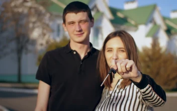 Stock Video Couple Happily Showing Keys To Their New House For PC