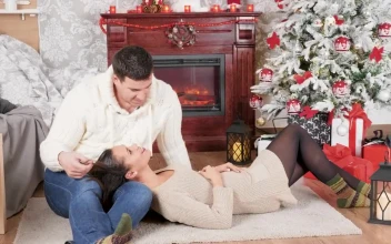 Stock Video Couple Enjoy Christmas Romance In Front Of Fireplace For PC