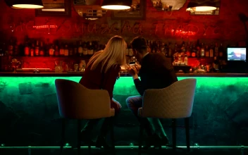 Stock Video Couple Checking Something In A Smartphone In A Bar For PC