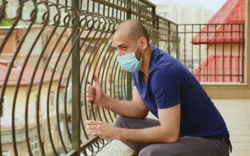 Stock Video Coronavirus Worries Man In Face Mask Sitting On Balcony For PC