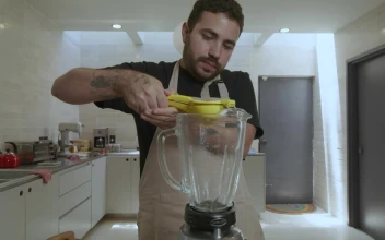Stock Video Cook Adding Lemon To A Blender For PC