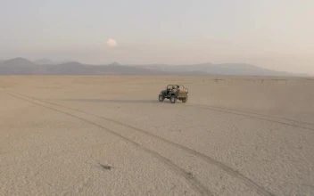 Stock Video Convertible Jeep Crossing A Large Desert In Aerial Shot For PC