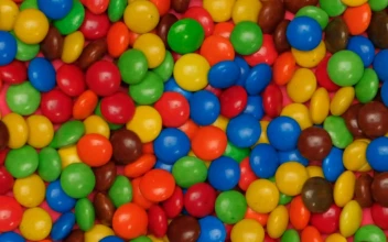 Stock Video Colored Chocolates Jumping On A Pink Background For PC