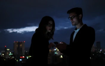 Stock Video Colleagues Looking At Information On Mobile Phone Screen For PC