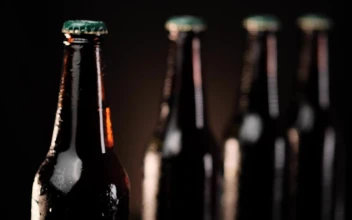 Stock Video Cold Beer Bottles In A Row On A Dark Background For PC
