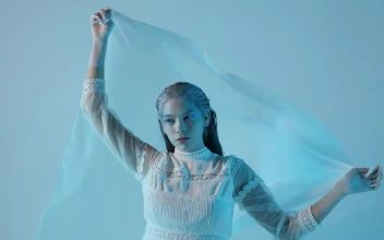 Stock Video Cold And Pale Looking Woman On A Blue Background For PC