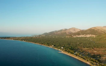 Stock Video Coastal Village Nested Between Two Mountains For PC