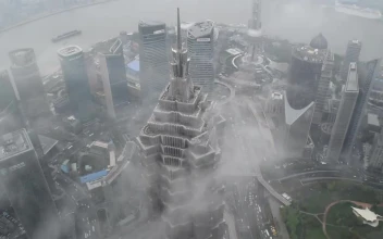 Stock Video Clouds Passing By A Skyscraper In Shanghai For PC
