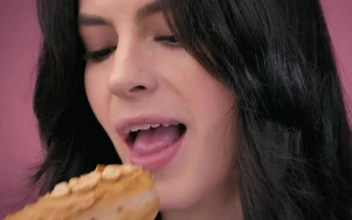 Stock Video Face Of A Girl While Biting Into A Peanut Donut For PC