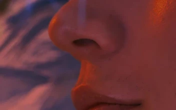 Stock Video Face Of A Gay Man Smelling Flowers For PC
