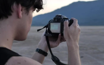 Stock Video Face Of A Boy Taking Pictures In A Desert For PC