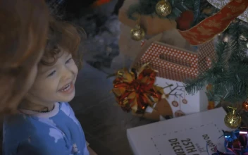 Stock Video Excited Girl Opening Gifts On Christmas Morning For PC