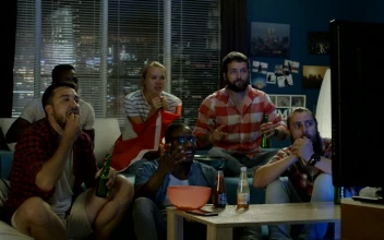 Stock Video Excited Friends Celebrating In Front Of The Tv For PC